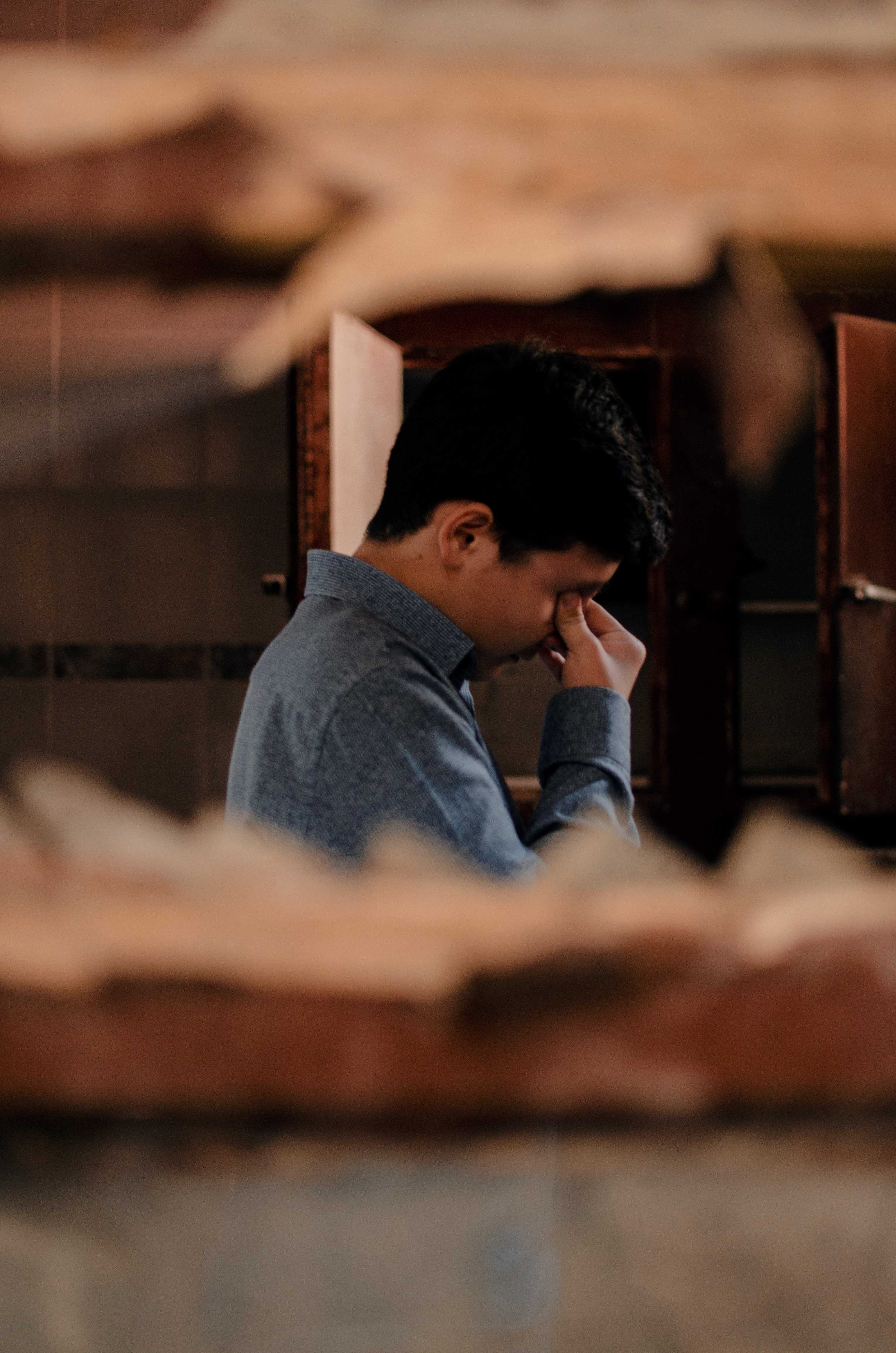 Man looking stressed, pinching his eyes